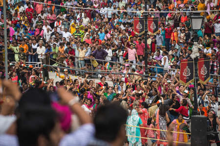 AMRITSAR PANJAB, INDIA, JULY 11, 2017 : The India-Pakistan Wagah Border Closing Ceremony. The flag ceremony happens at the border gate, two hours before sunset each day on 11 July 2017のeditorial素材