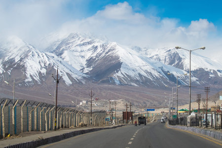 LEH, INDIA - APRIL 10 2015. A Cars on the road at high altitude Ladakh-Leh road in Himalayan mountain, state of Jammu and Kashmir, India.のeditorial素材