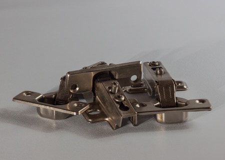 Furniture accessories. Door hinges on grey backgroundの写真素材