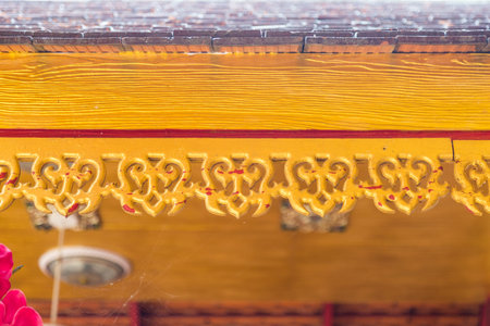 Retro wooden cornice decorate on eaves in Buddhist temple Thailand.
