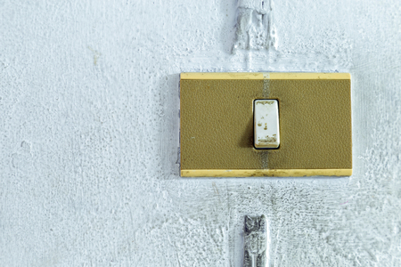 A closeup in a old light switch on the old white wall, blank for copy space.の写真素材