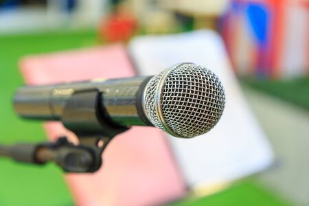 Microphone on microphone stand and blurry note stand background.の写真素材