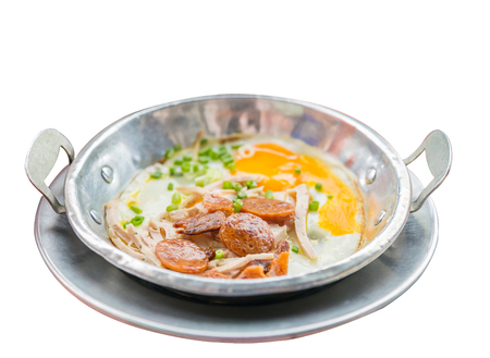 A pan fried egg with toppings isolated on white background.の写真素材