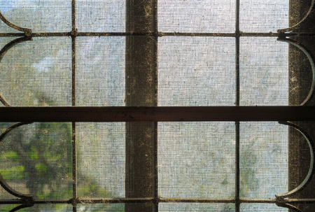 An old dirty aluminium wire net on window with dust.の写真素材
