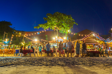 Rayong, Thailand - October 14, 2018 : Tourist family choosing restaurants for dinner on the Samet island at night, Samet islands favourite tourist attractions in Thailand.のeditorial素材