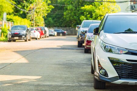 Many car parking at side village road with home and many cars parking in working day while lockdown from covid and work from home.の写真素材