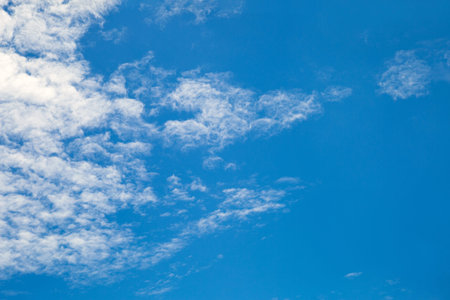 White clouds spread out from left side in blue sky in summer day