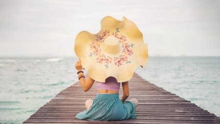Close up portrait back young Asian woman in a purple bra touching a hat on her head on a wooden...