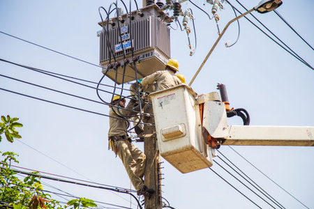 Nonthaburi, Thailand- May 19, 2021: Electrical wireman are repairing cable on street lights.