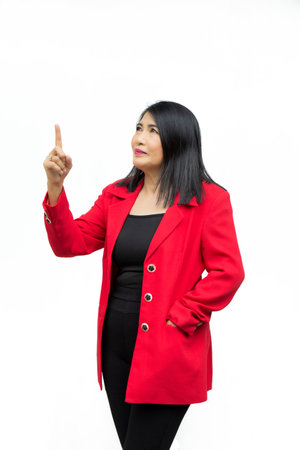 Portrait confident middle-aged Asian woman wearing red jacket points a thumb up, on a white background.の写真素材
