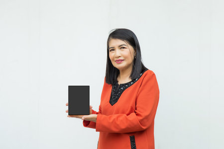 Portrait confident middle-aged Asian woman wearing red jacket pick a pocket isolated on white...