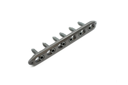 A surgical plate with screws for bone fixation, designed for stability and supportの写真素材