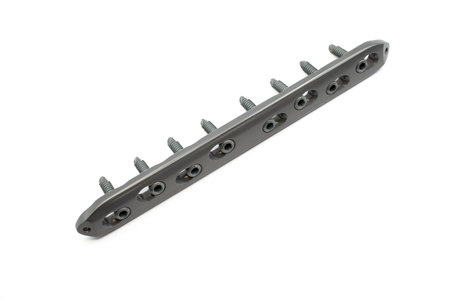 A surgical implant with screws, designed for femoral fixation, showcasing precision engineeringの写真素材