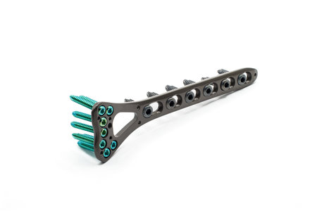 A Surgical Distal Raius Plate with screw on a white background. A plate is used to fix a fractured a...