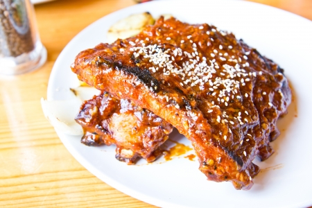 grilled pork ribs steak on white plateの写真素材