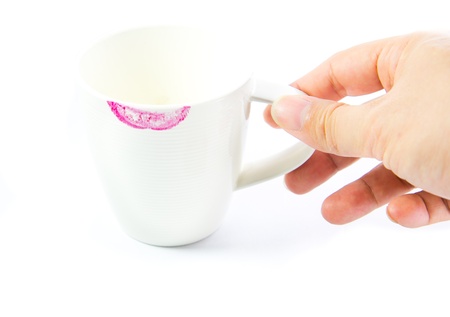 Red lipstick mark on a white tea cup isolatedの写真素材