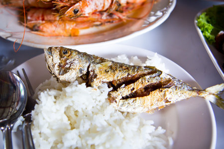 Fried Fish served with hot rice in restaurant