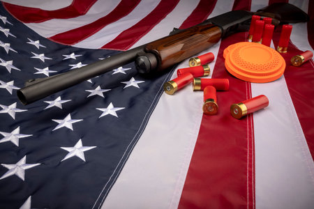 Shotgun with bullets and flying target on USA flag  , Can be used as a background