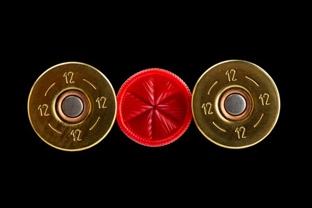 Close up of 12-gauge shotgun shell on black isolated