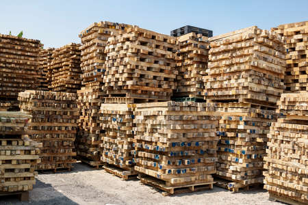 Stacks of used Wooden Pallets at a Recycling business areaの写真素材