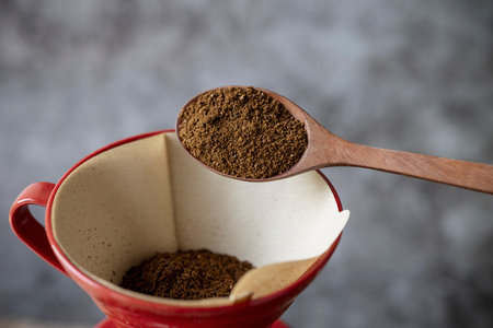 Drip or brewed coffee with paper dripping and coffeepot on coffee bean texture background , Wooden...
