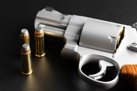 Revolver handgun and .44 bullets on black backgroundの写真素材