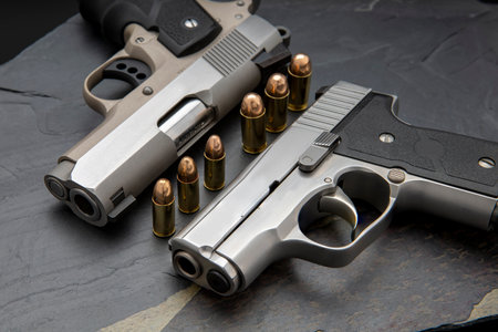 Automatic handguns and bullets on black stone backgroundの写真素材