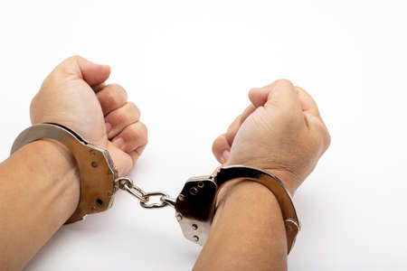 Handcuffs on arrested human hand, Loss freedomの写真素材