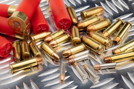 Difference of size of ammunition gun bullets on daimond plate background