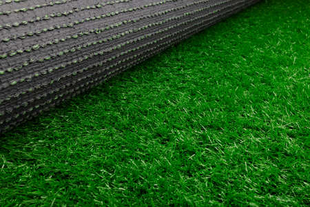 Roll of fake green grass or artificial green grass on white backgroundの写真素材