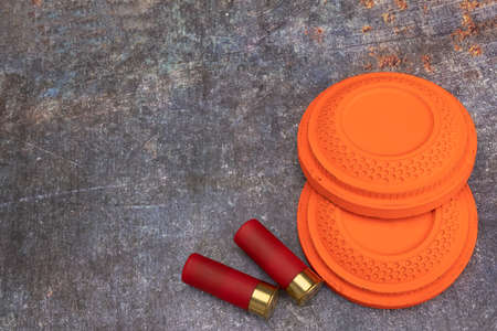 Clay disc flying targets and shotgun bullets  on texture background ,Clay Pigeon target gameの写真素材