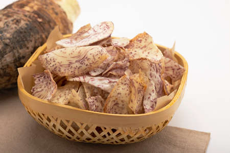 Taro, fried slice of taro in bamboo basket  on white background , Food and dessert conceptの写真素材