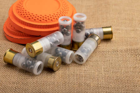 Clay shooting target with shotgun shell on sackcloth background , Clay pigeon shooting gameの写真素材