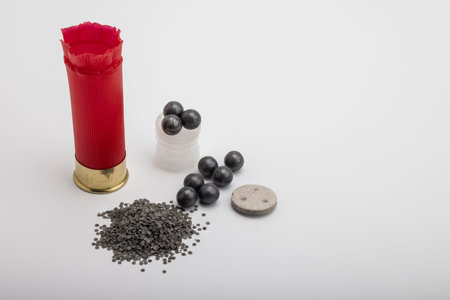Parts of shotgun shell component on white background