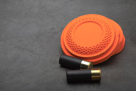 Clay shooting target and shotgun bullets