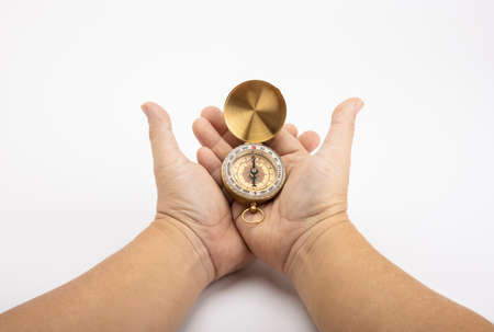 Classic compass , Vintage compass in hand on a white backgroundの写真素材