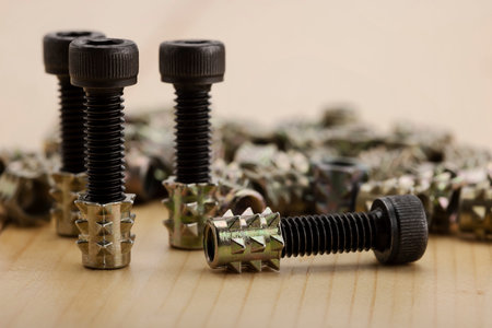 Steel anchor bolts on wooden background , Equipment for wood construction