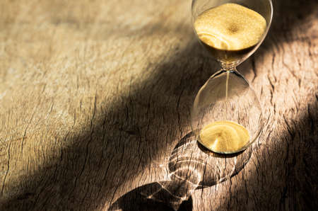 Sand clock , Hourglass as time passing on wooden background , Life time conceptの写真素材