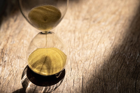 Sand clock , Hourglass as time passing on wooden background , Life time concept