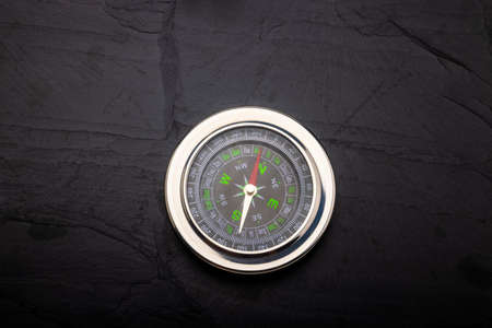 Navigation compass on black slate backgroundの写真素材