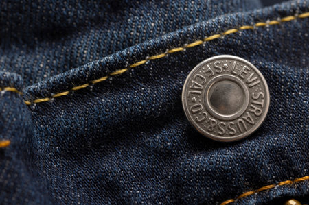 Bangkok, Thailand - October29,2021 : Metal buttons on blue jeans backgroundのeditorial素材