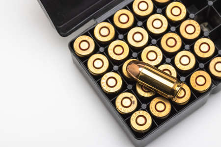 .45 ACP bullet pistol gun with ammunition box on white backgroundの写真素材