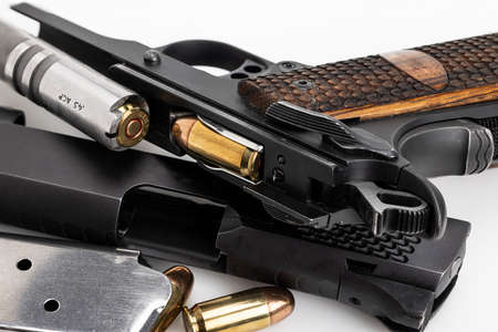 .45 automatic hand gun barrel and ammunition location on white backgroundの写真素材