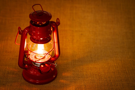 Red oil lantern on burlap background , Vintage lamp
