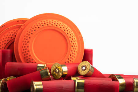 Clay disc flying targets and shotgun bullets on white background ,Clay Pigeon target gameの写真素材
