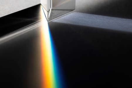 Triangular Prism dispersing sun beam splitting into a spectrum on white backgroundの素材 [FY310190095763]