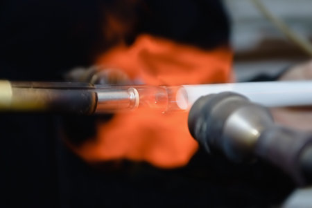 Gas burner. Soldering electrodes to a glass tube to neonの写真素材