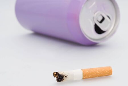 The extinguished cigarette near to a tinの写真素材