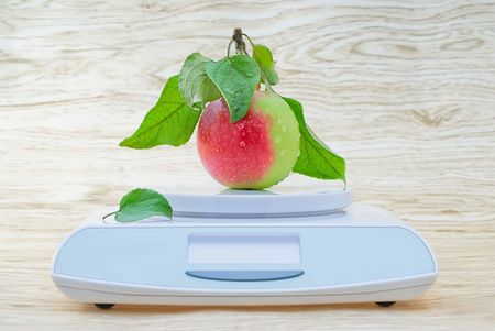 Electronic scales and red appleの写真素材