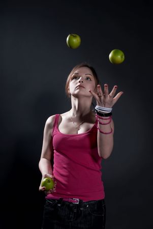 Virtuoso juggler- podbrasovanie green apples jugglingの写真素材